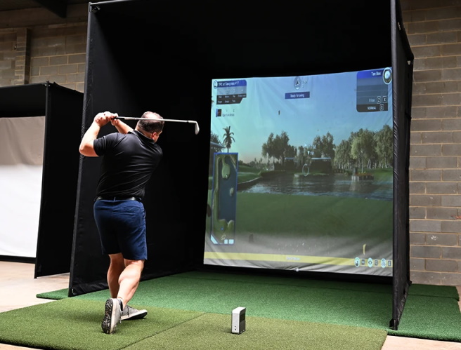 Man swinging in a SkyTrak SimBay Golf Simulator