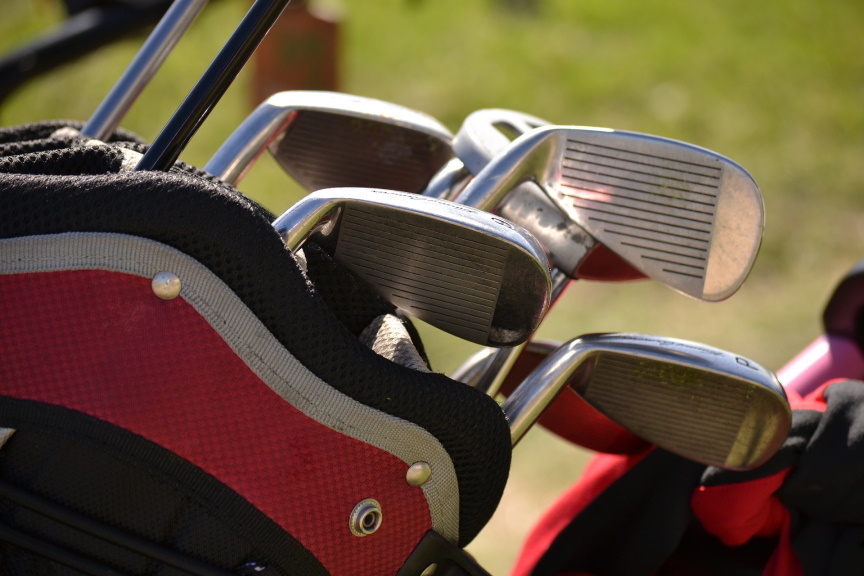 Golf clubs in a red bag